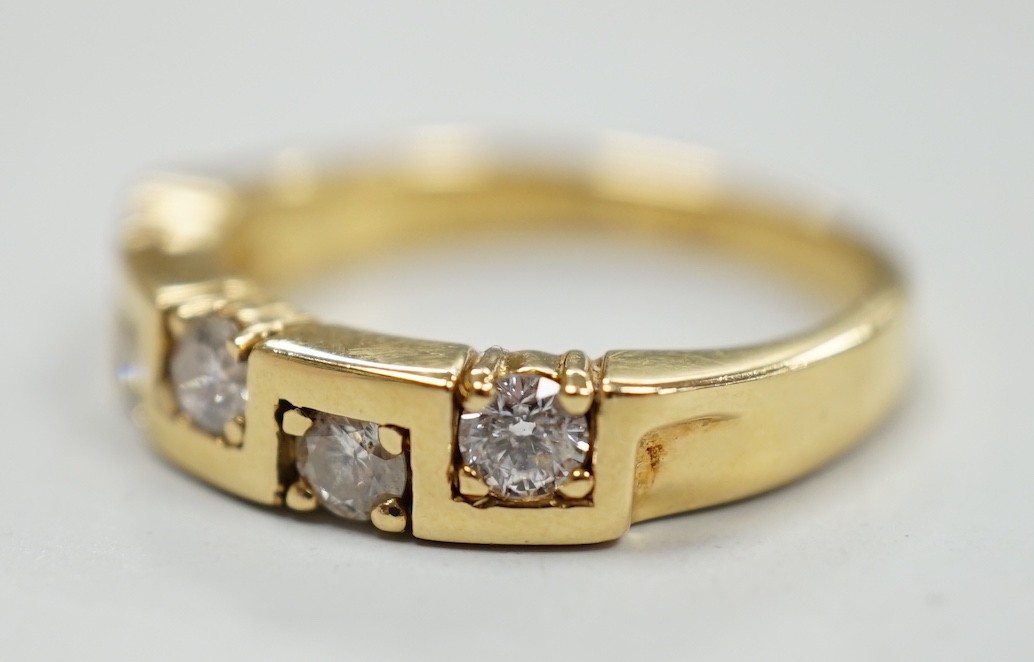A modern 18ct gold and five stone diamond set half hoop ring, size M/N, gross weight 4.9 grams.